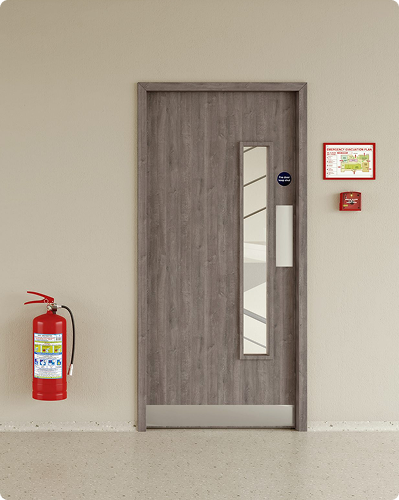 Wooden fire door with glass panels and fire safety label