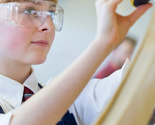 Young student measuring timber pieces