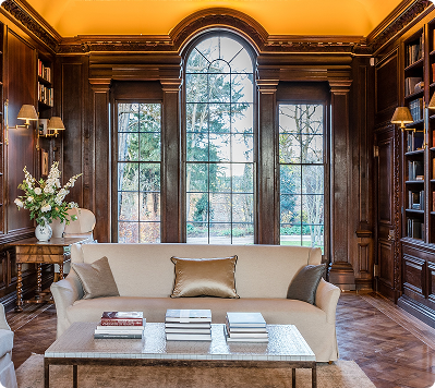 Elegant timber-panelled room with sofa and large window