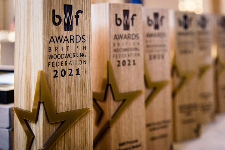 Row of BWF 2021 award trophies on a shelf