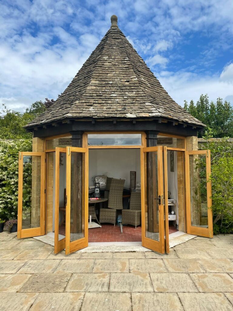 Timber-framed summerhouse with open doors