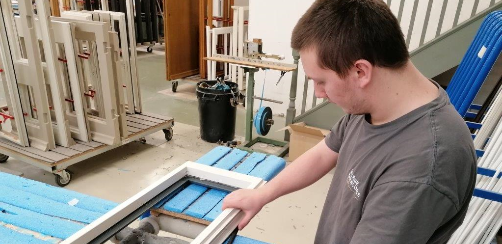 Man using a power tool in a manufacturing setting