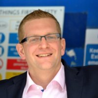 Smiling man in glasses at an event