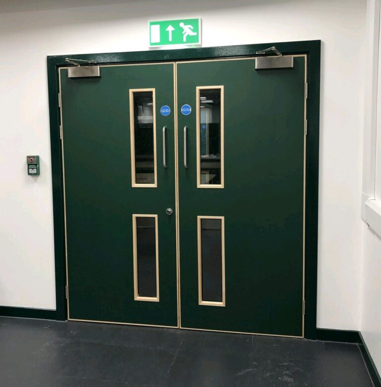 Green fire exit doors with white push bar