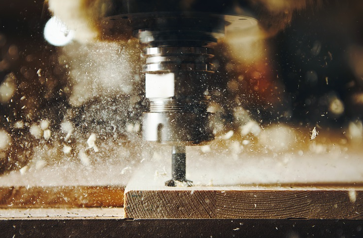 Router cutting through wood