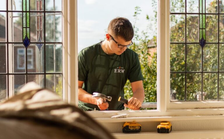 A young man using a hammer and chisel