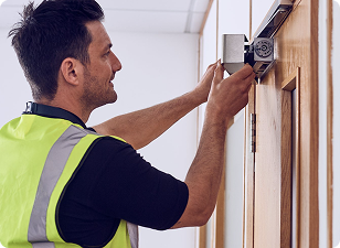 Man using spirit level on doorframe