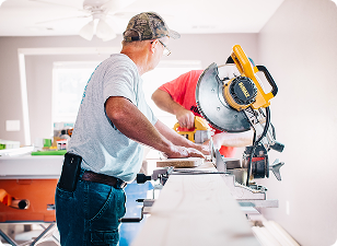 Man operating large circular saw in workshop