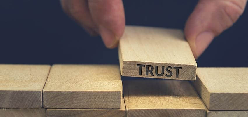 Trust written on a wooden building block