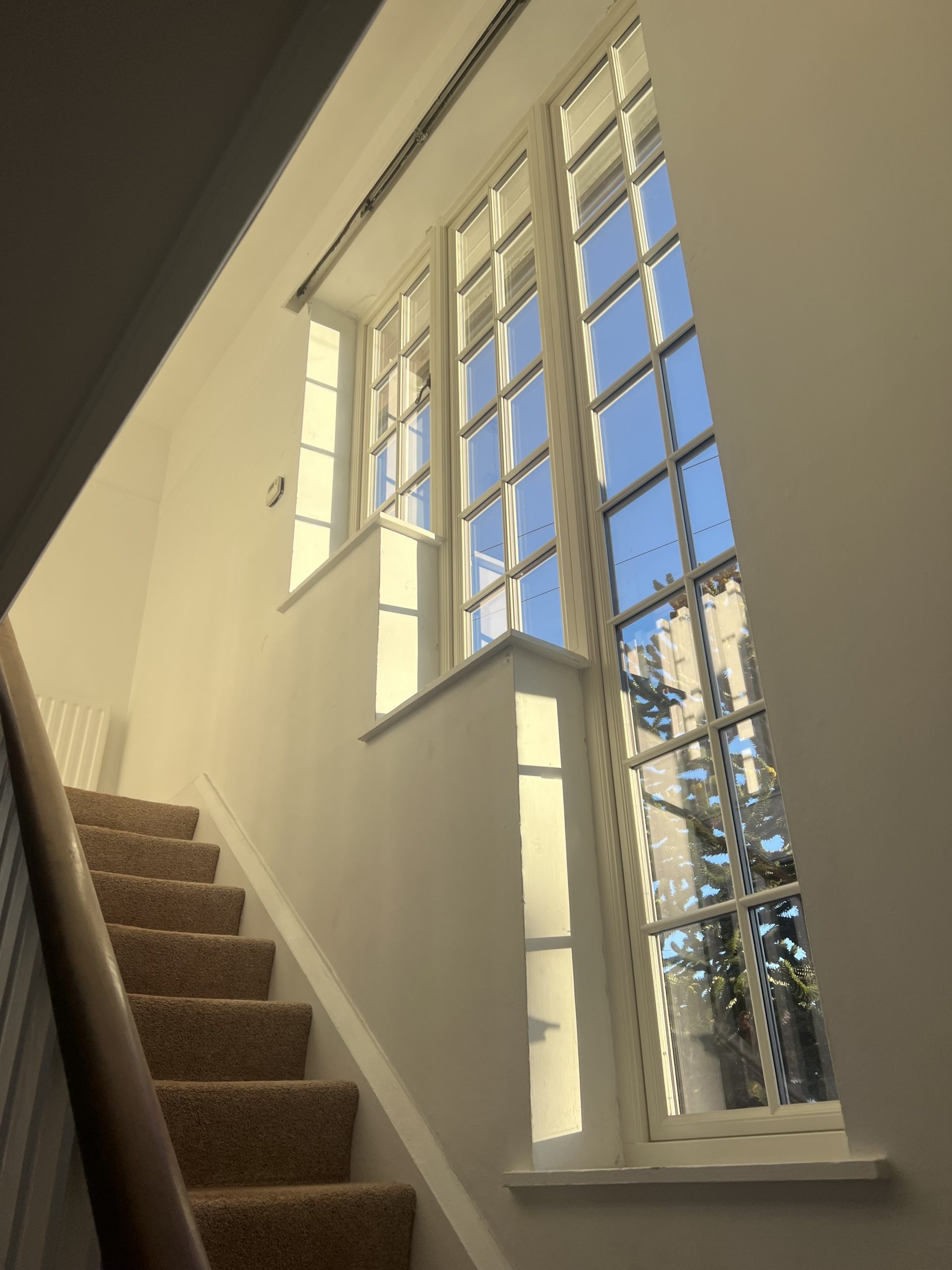 Staircase with a bespoke window screen 